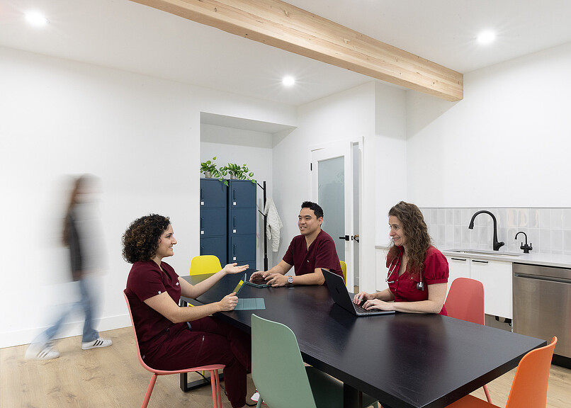 Open Wellness doctors seated at table