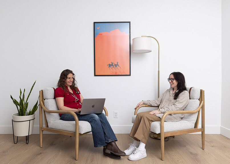 Open Wellness doctor and patient conversing in chairs