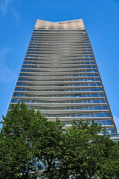 A tall building with trees in front of it.