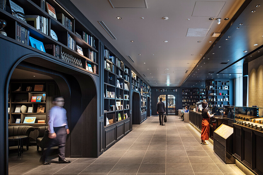 People walking in a library.