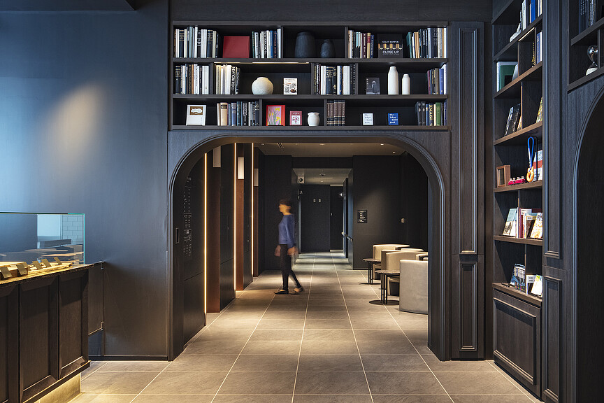 A person walking through a library.