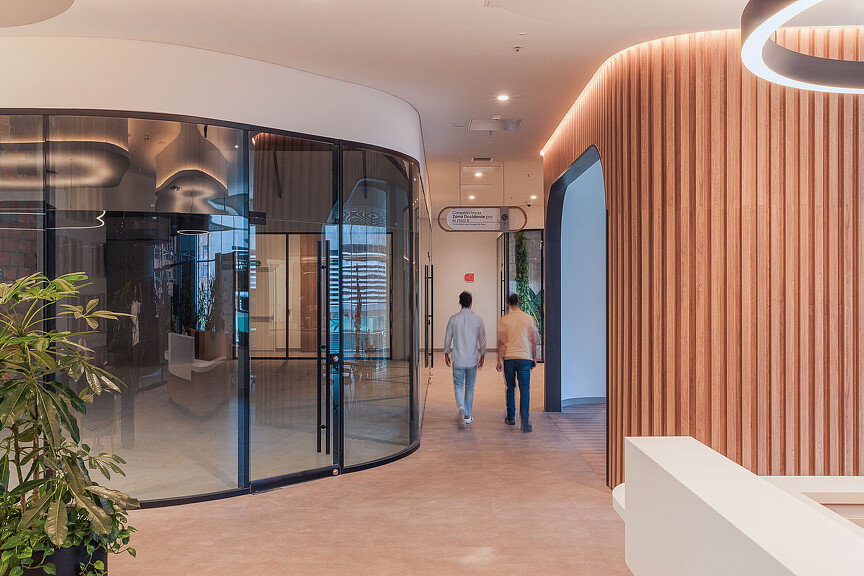 Two people walking down Oviedo Medical Tower hallway