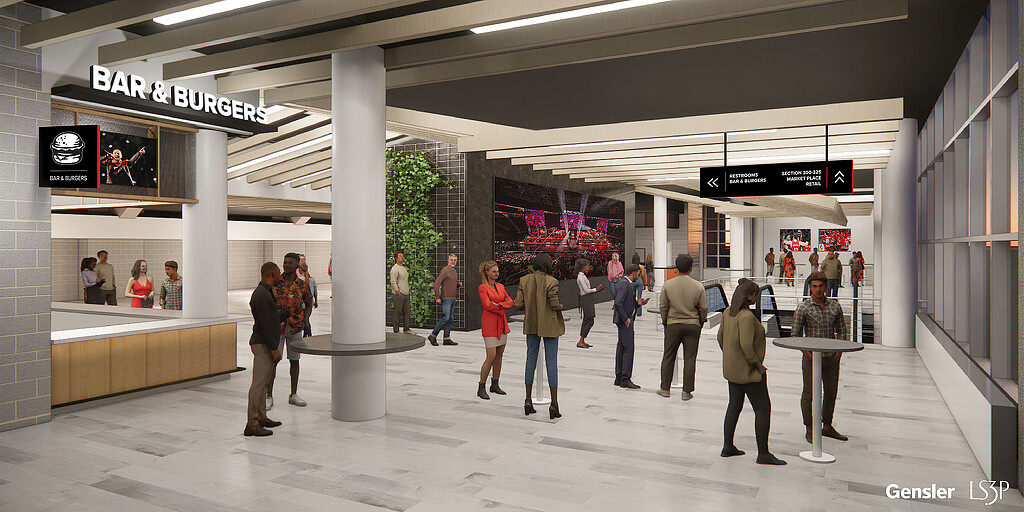 A group of people walking in a large building.