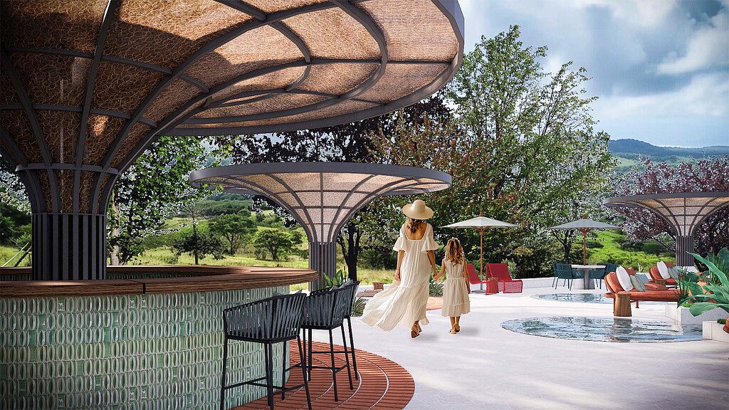 A couple of people walking on a deck by a pool.