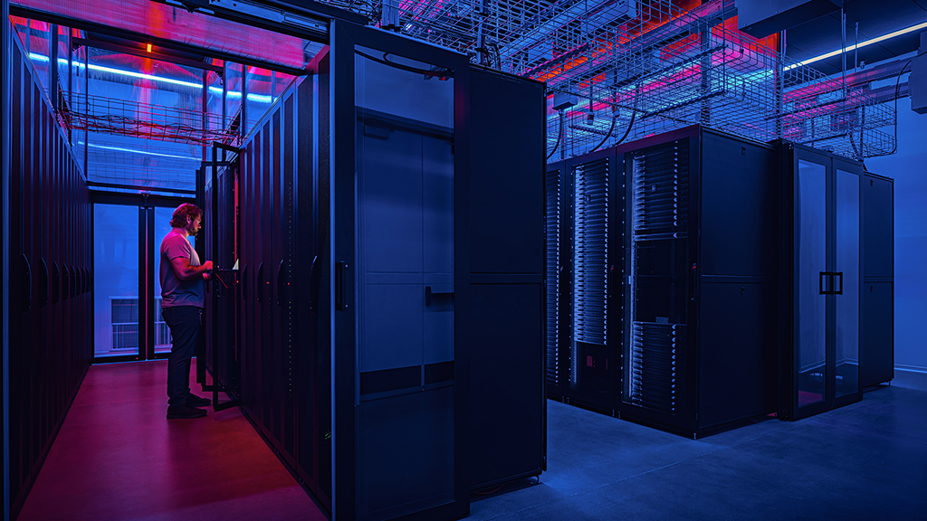 A person standing in a server room.