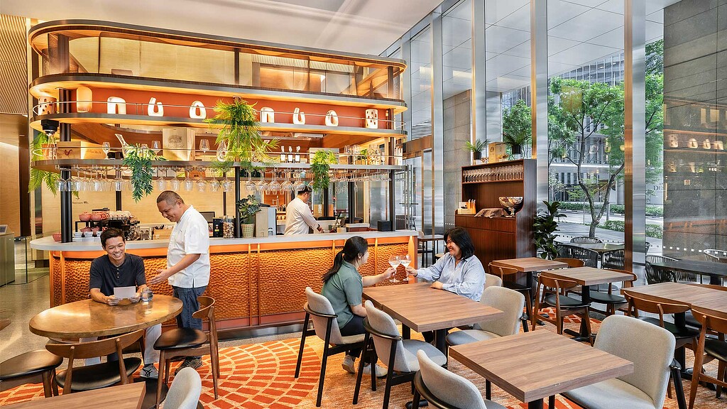 A group of people sitting at tables.