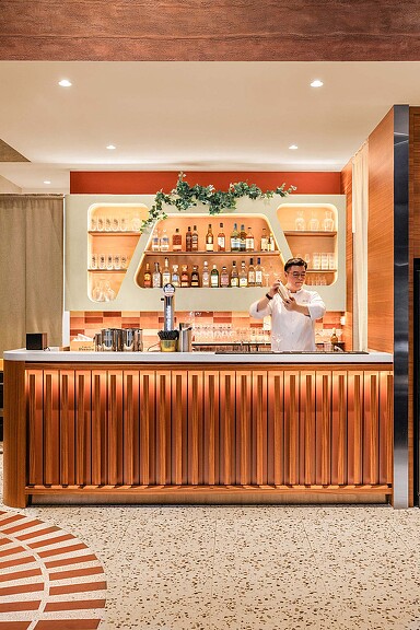 A person standing behind a counter.