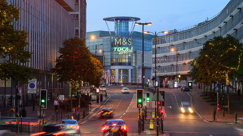A city street with cars and buildings.