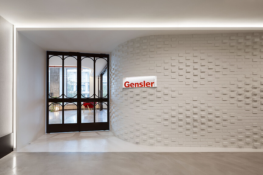 A white wall with a sign on it.