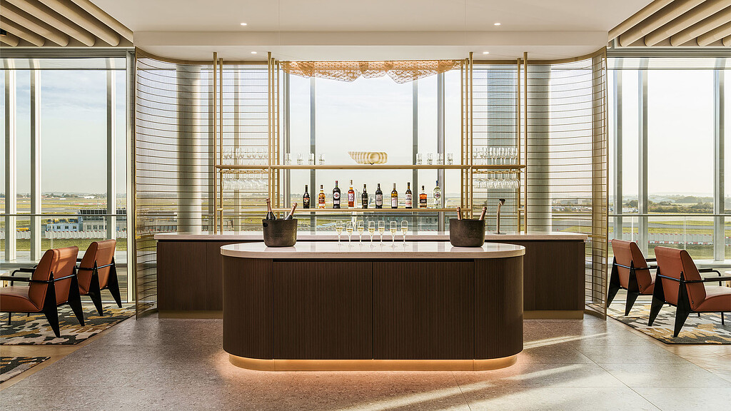 A room with a bar and chairs.