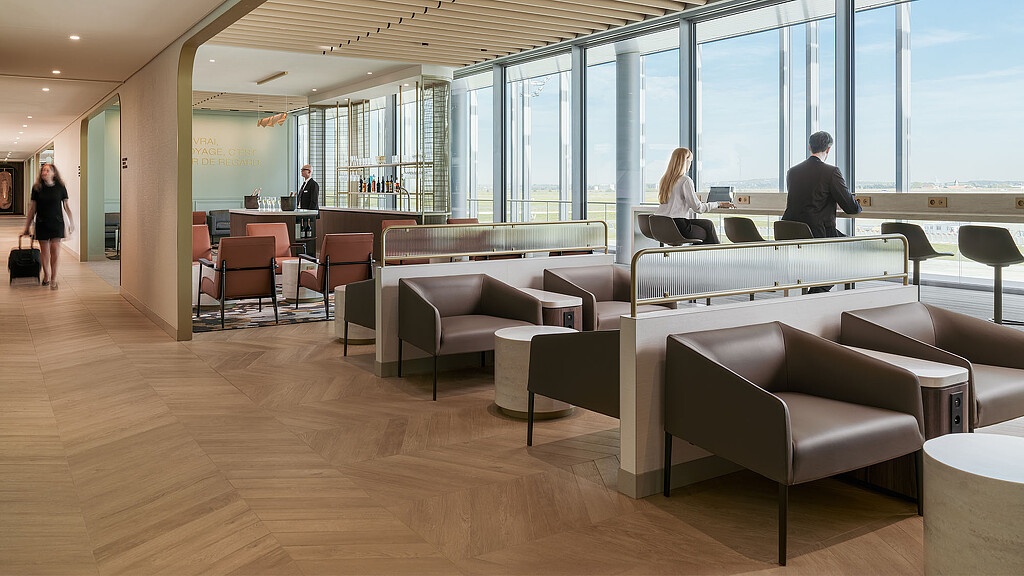 A room with a few people and a large window.