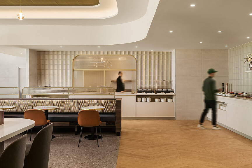 A couple of people in a kitchen.