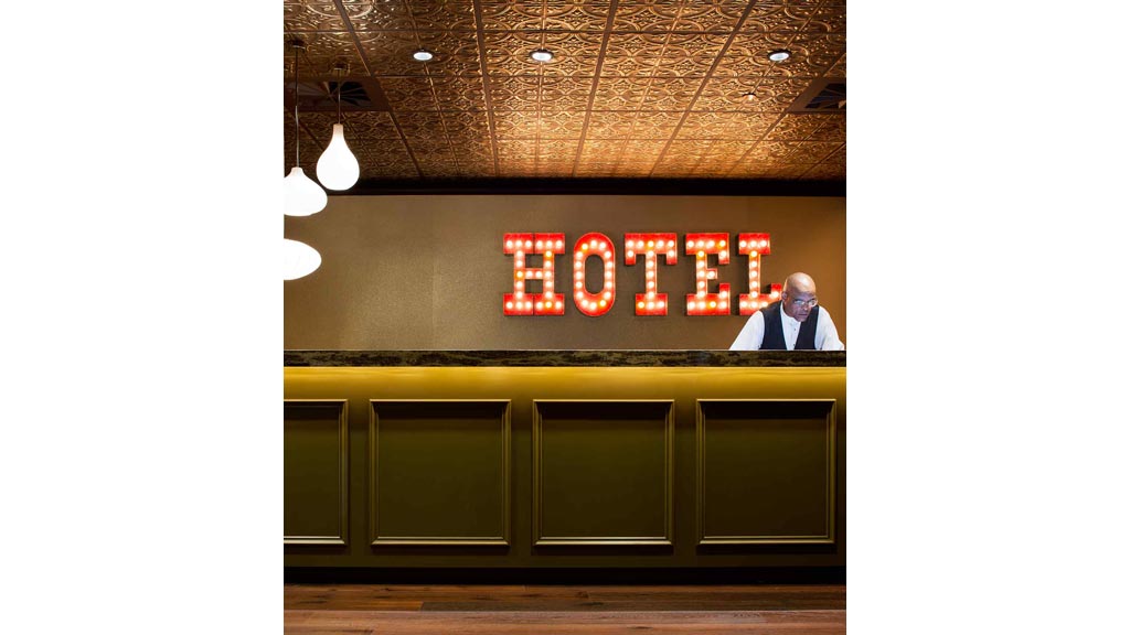 A person standing in front of a sign.