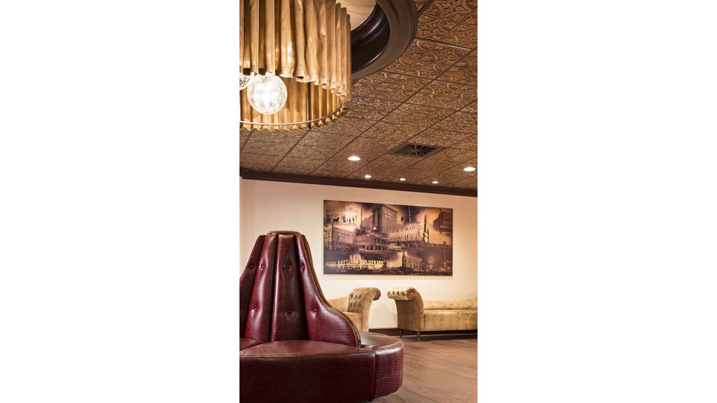 A room with a large chandelier and a couch.