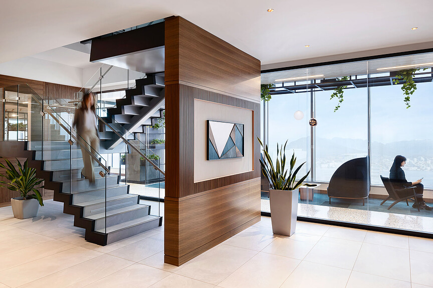 A modern looking staircase with a statue on the top.