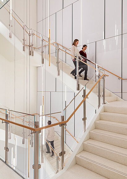 A few people walking up a flight of stairs.