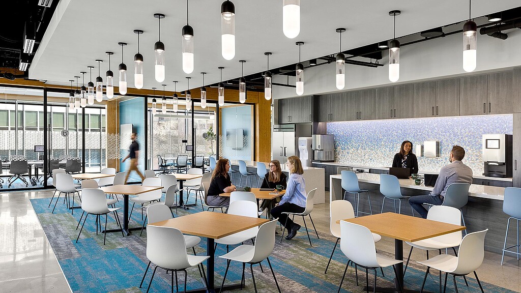 A group of people sitting at tables.