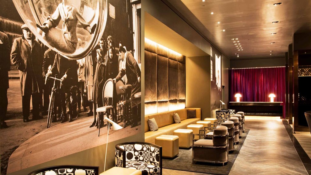 A room with a large wall of art.