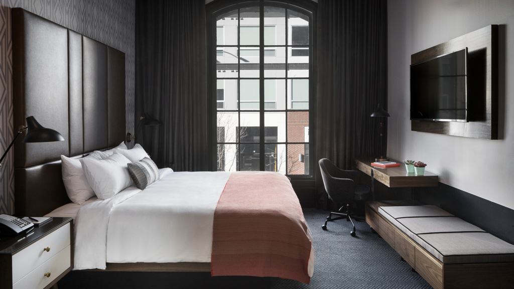 A bedroom with a large window.