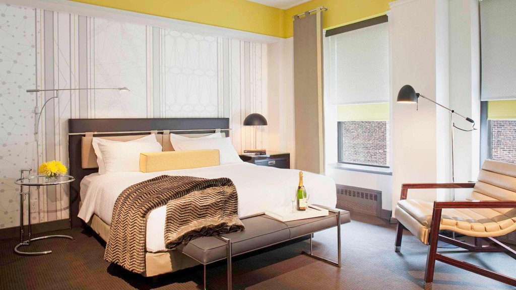 A bedroom with a bed and a table.