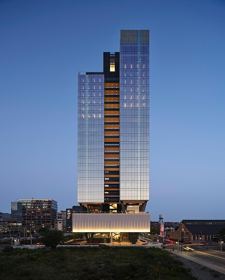 A tall building with a glass front.