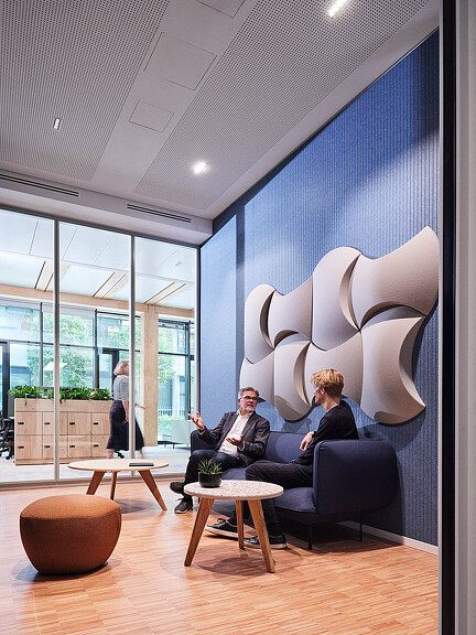 Synopsys Munich lounge space with textured wall art
