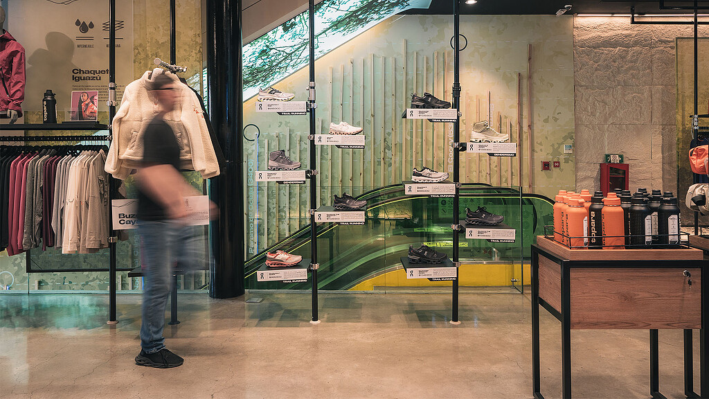 A person standing in front of a glass display case.