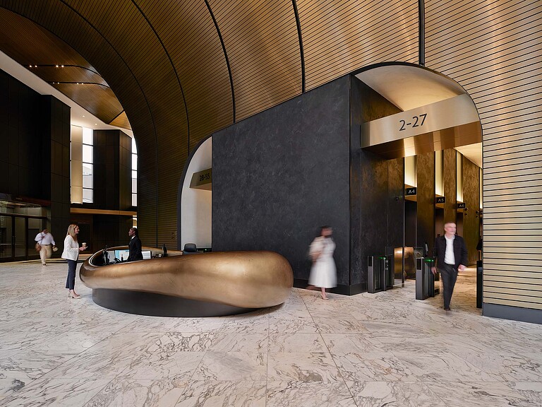 A group of people walking through a building.