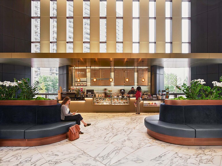 A person sitting on a couch in a large building.