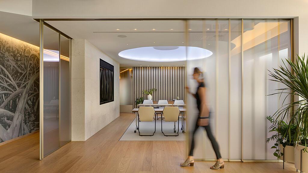 A man and woman dancing in a room with a table and chairs.