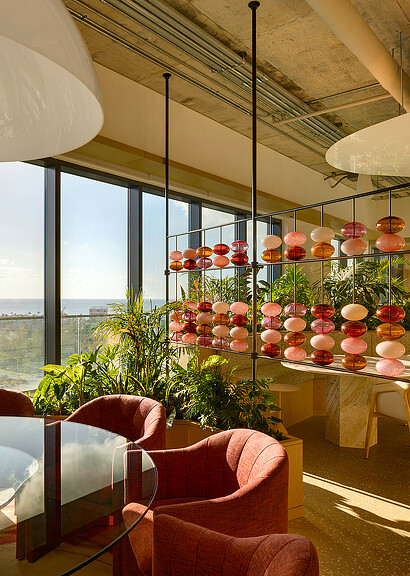 A room with a table and chairs and a window with a view of a city.