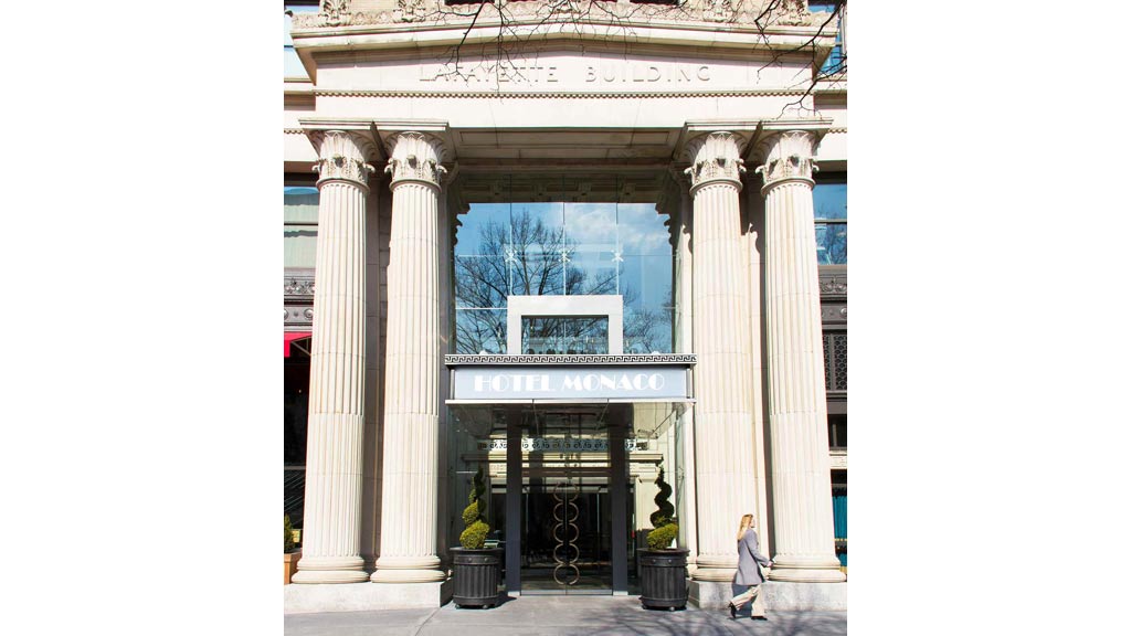 A building with columns and a sign.