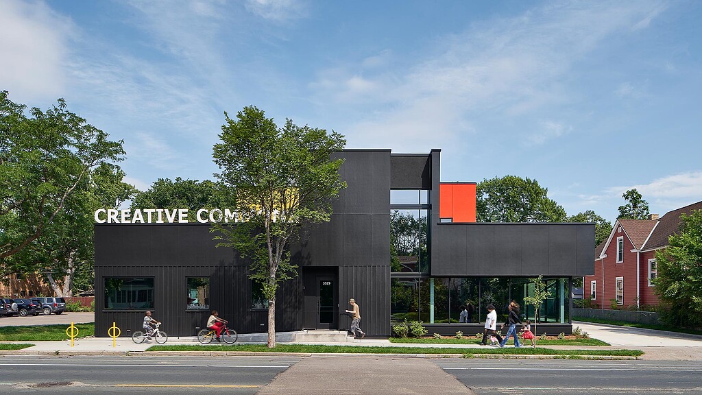 A building with a few people walking around.