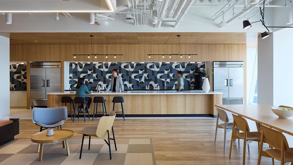 A group of people in a kitchen.