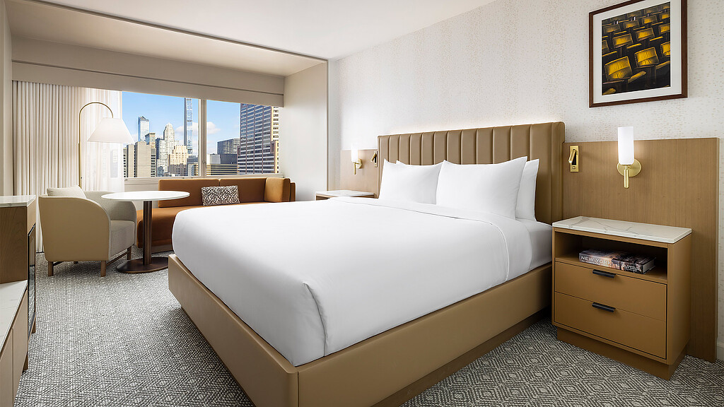 A bedroom with a large window.