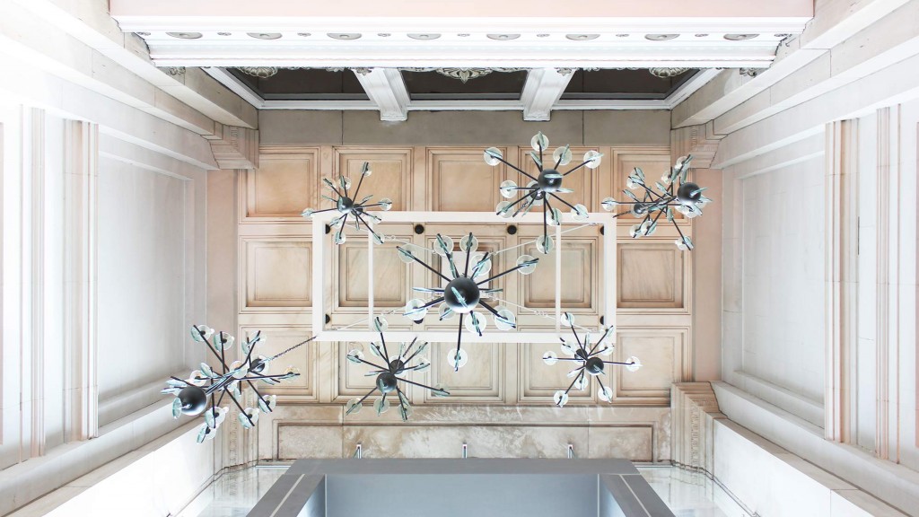 A room with chandeliers and a mirror.