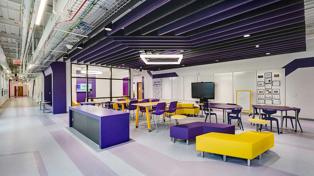 A room with colorful chairs and tables.