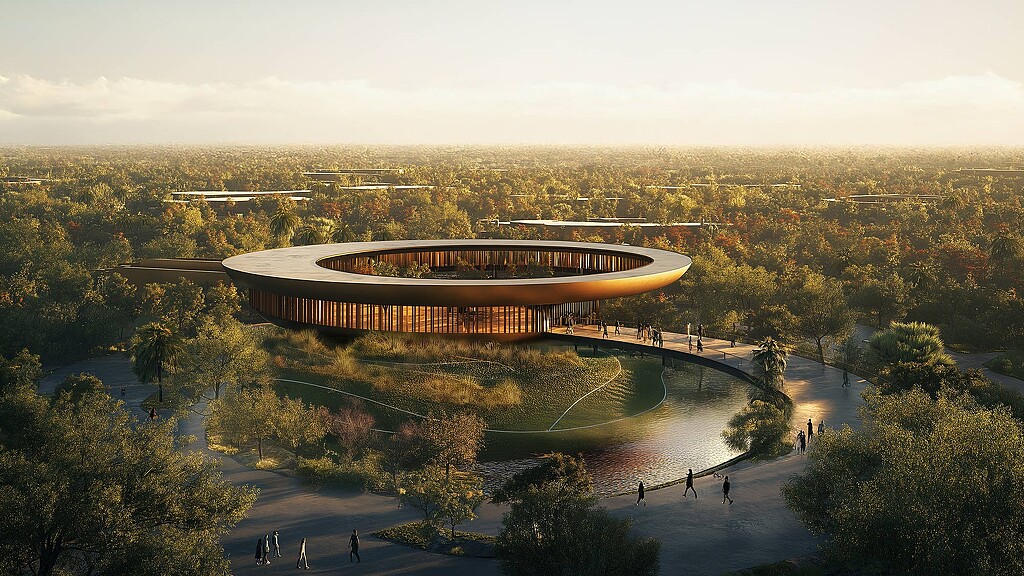 A large building with a large circular roof surrounded by trees.