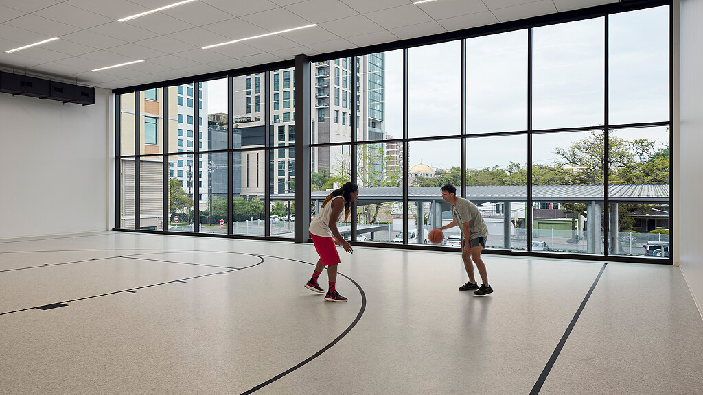A man and a woman playing basketball.