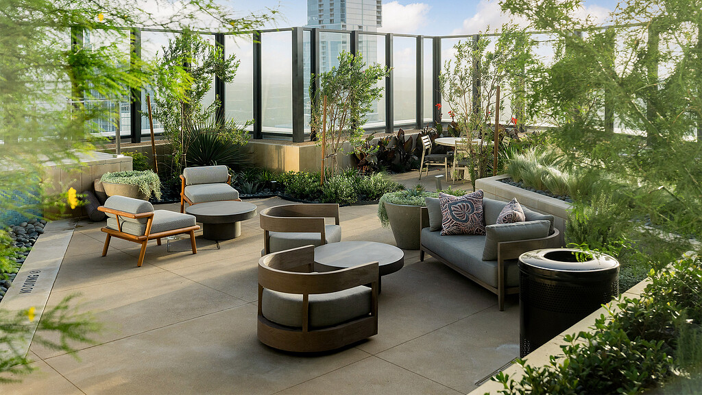 A patio with chairs and plants.
