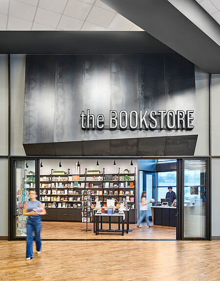 A person standing in front of a storefront.