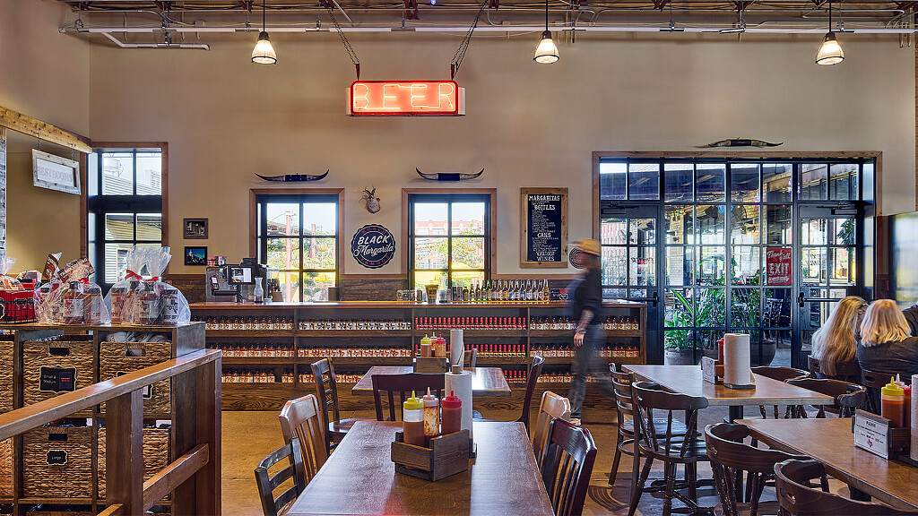 A restaurant with tables and chairs.