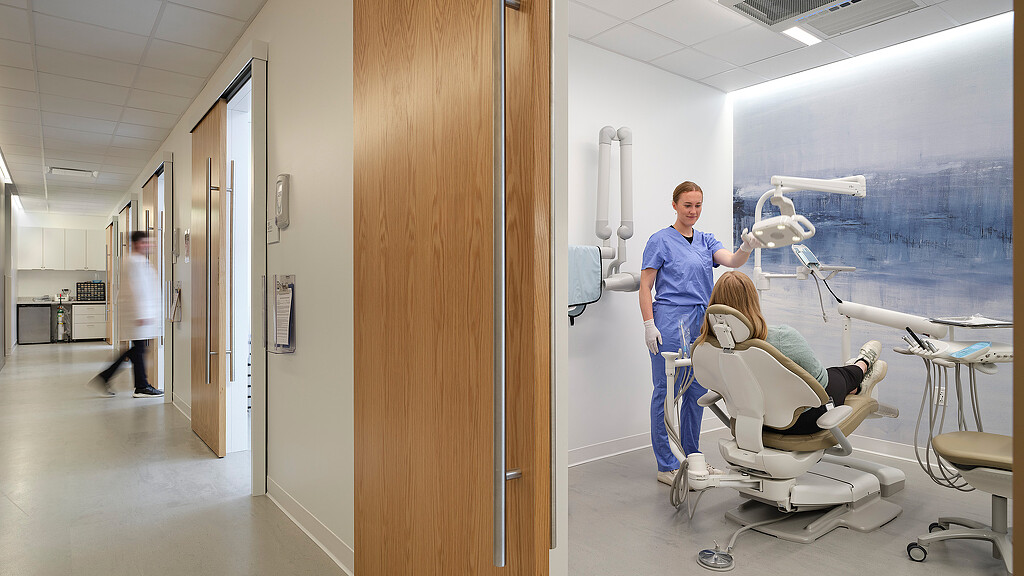 A man standing next to a woman in a hospital room.