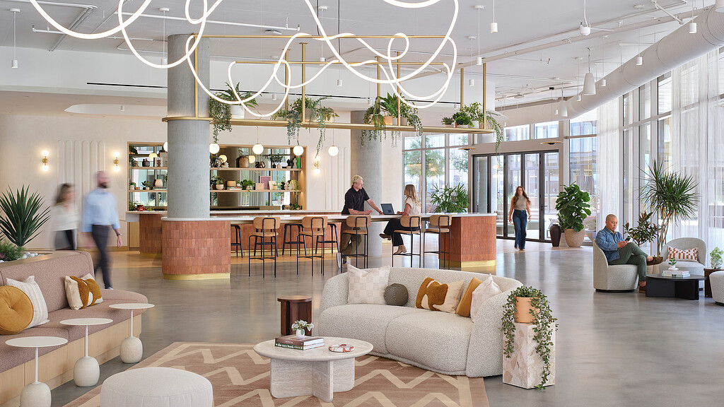 A large room with a large chandelier and a group of people.
