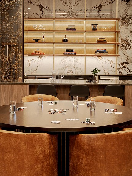 A table with chairs and glasses on it.