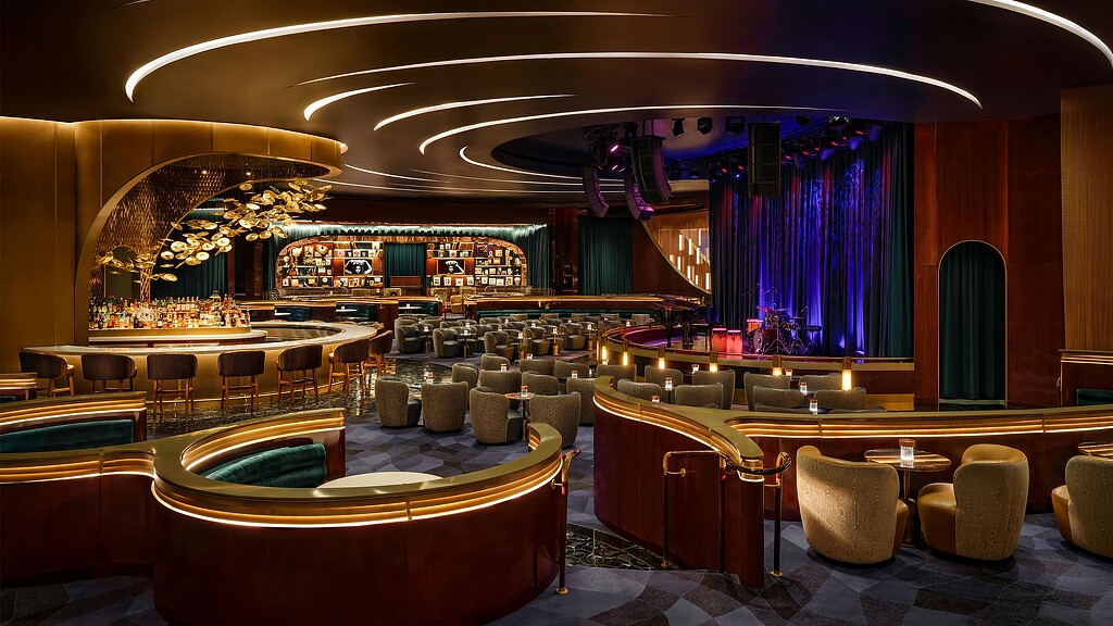 A room with a large round table and chairs.