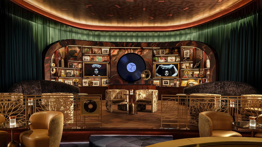 A room with a couch and chairs.