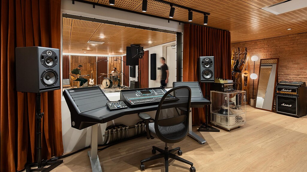 A studio with a large screen and speakers.
