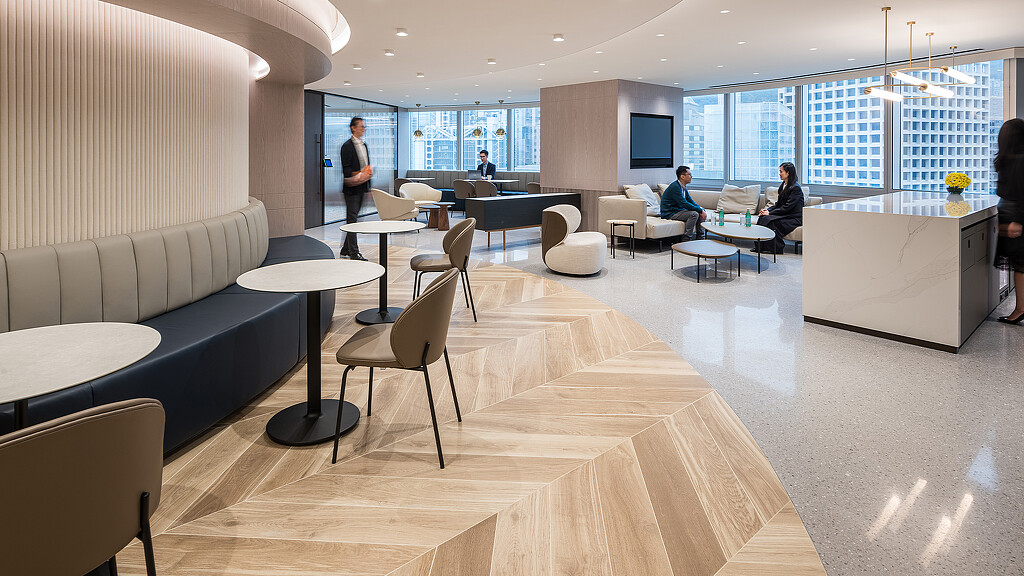 A room with a few people and a large window.