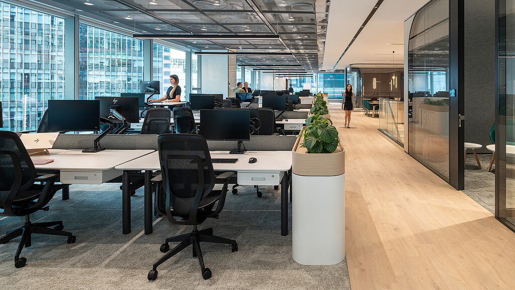 A room with a few people and computers.